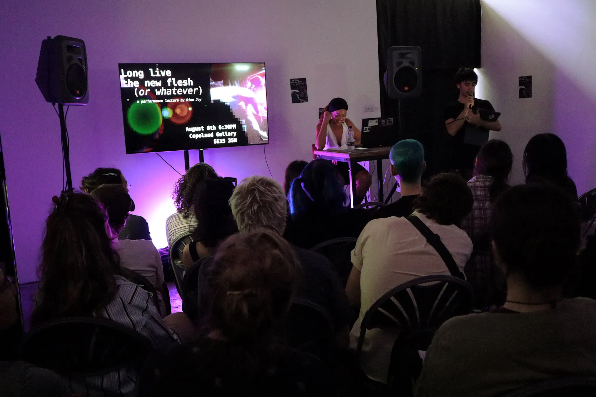 Crowd gathered in front of projection during Dian Joy’s lecture
