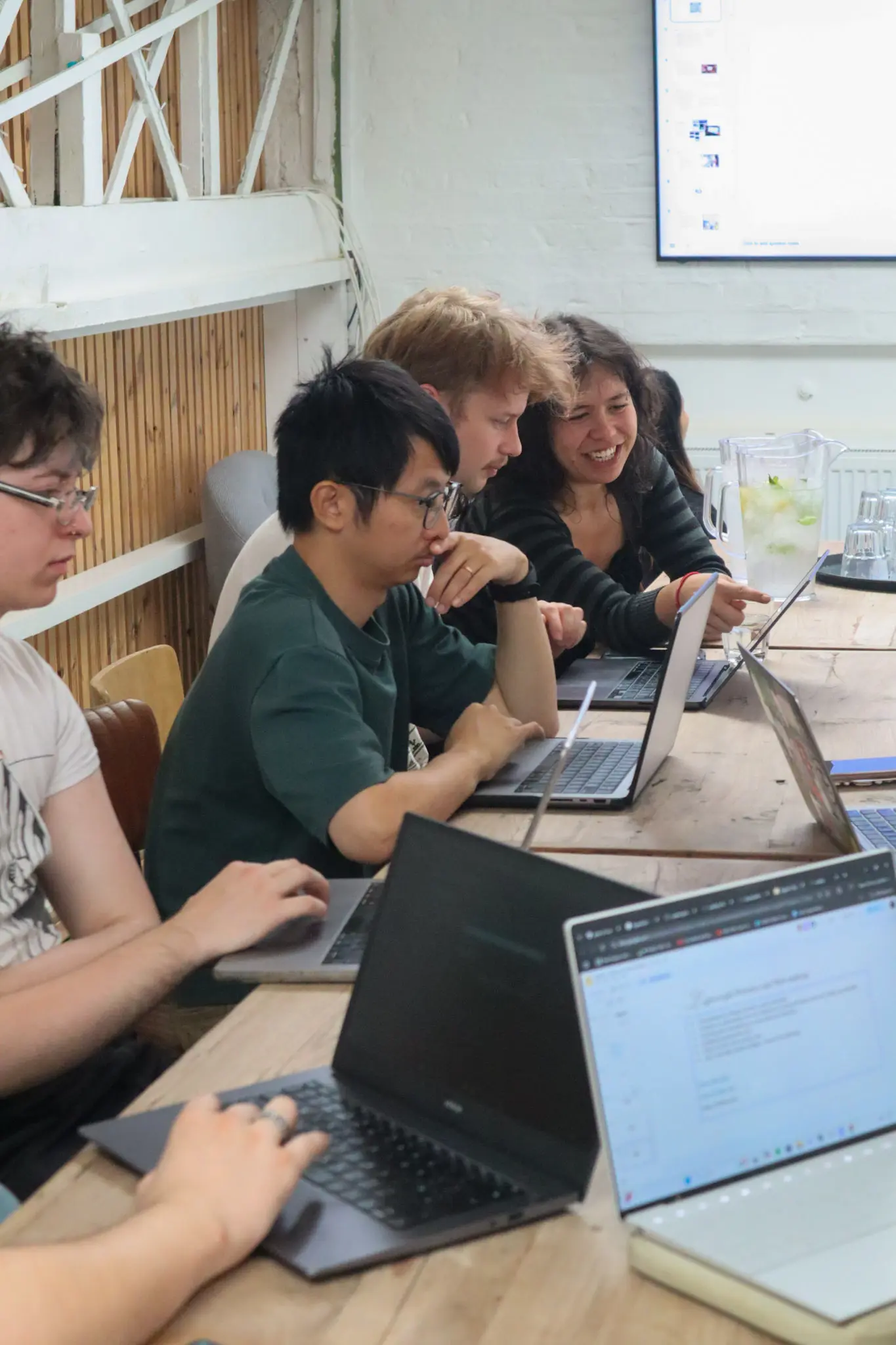 Workshop table with laptops open during glitch session
