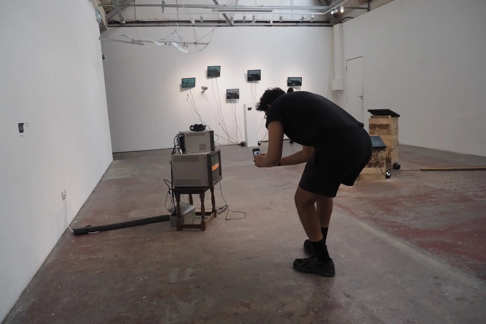 Installation view with 3D scan visuals on wall