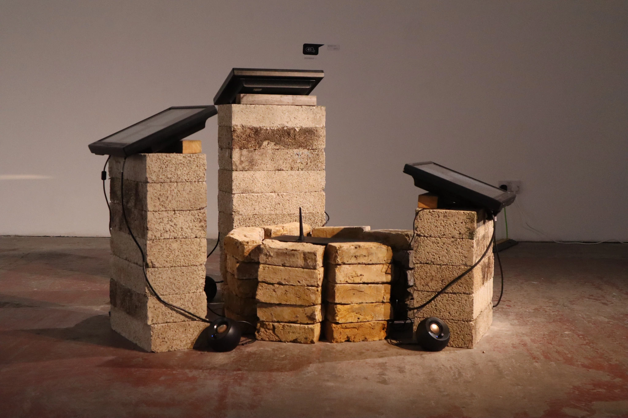 Monitors stacked on-top cinder blocks