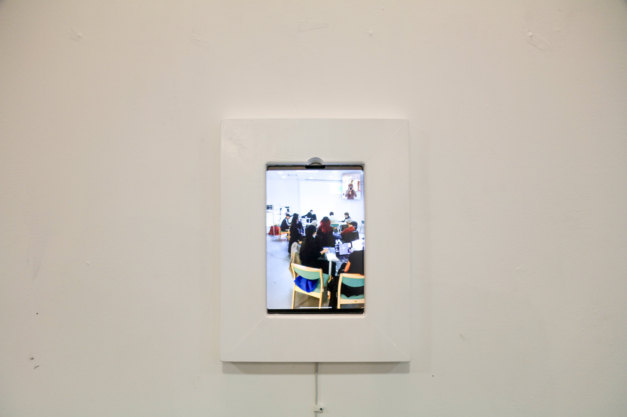 An iPad on Facetime, blending into the wall