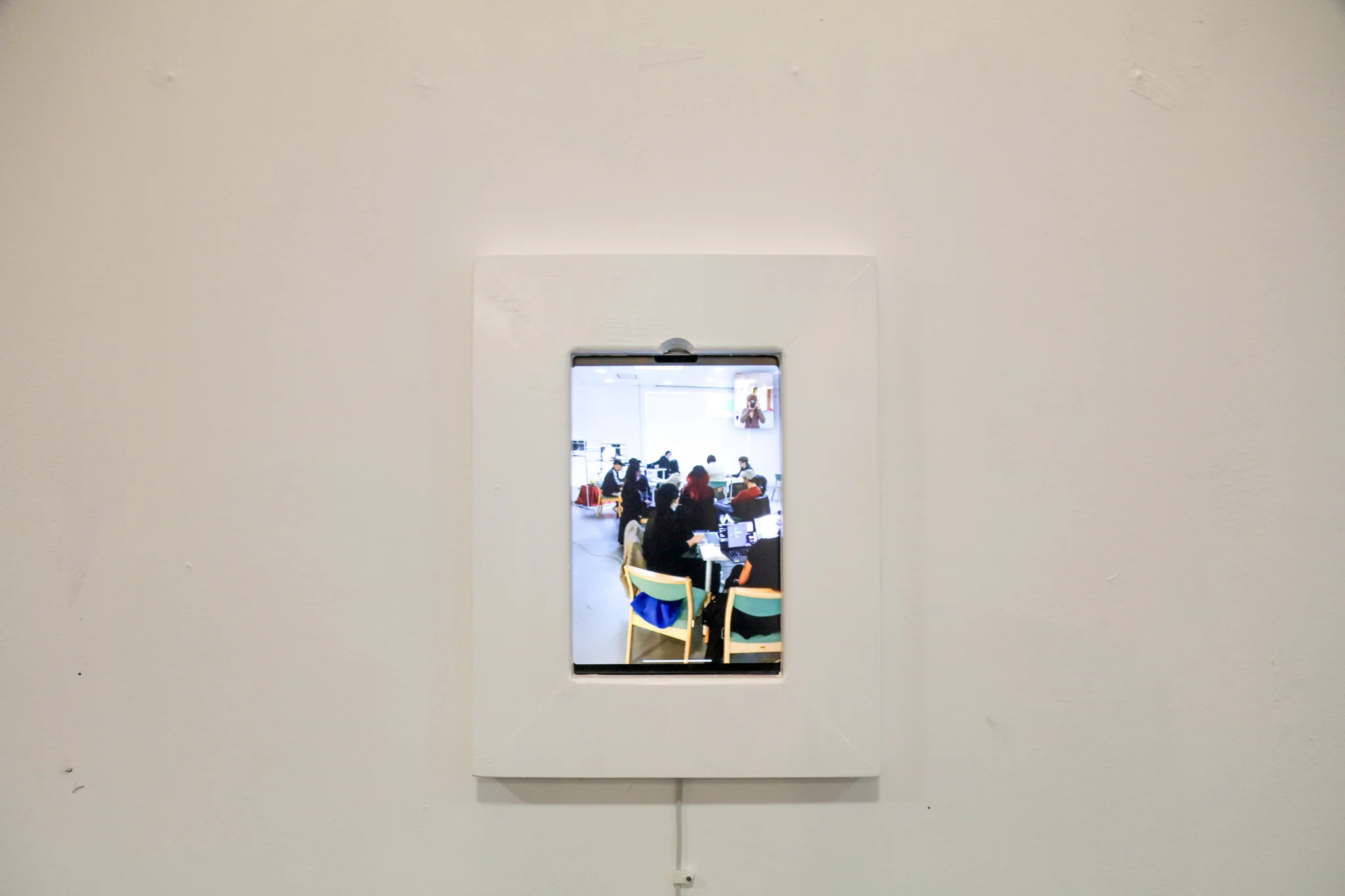 An iPad on Facetime, blending into the wall