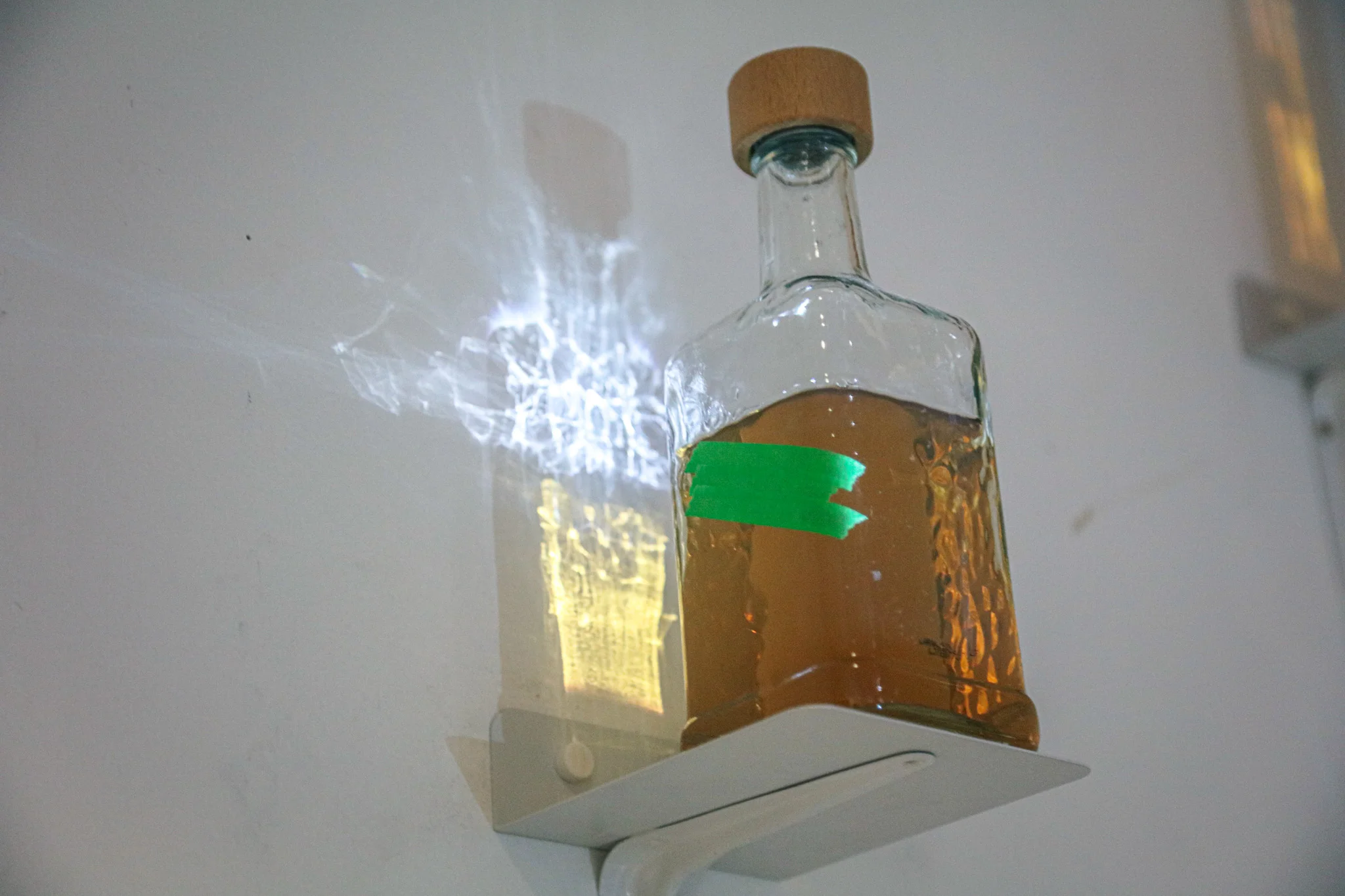 Bottles on a wall, lit up