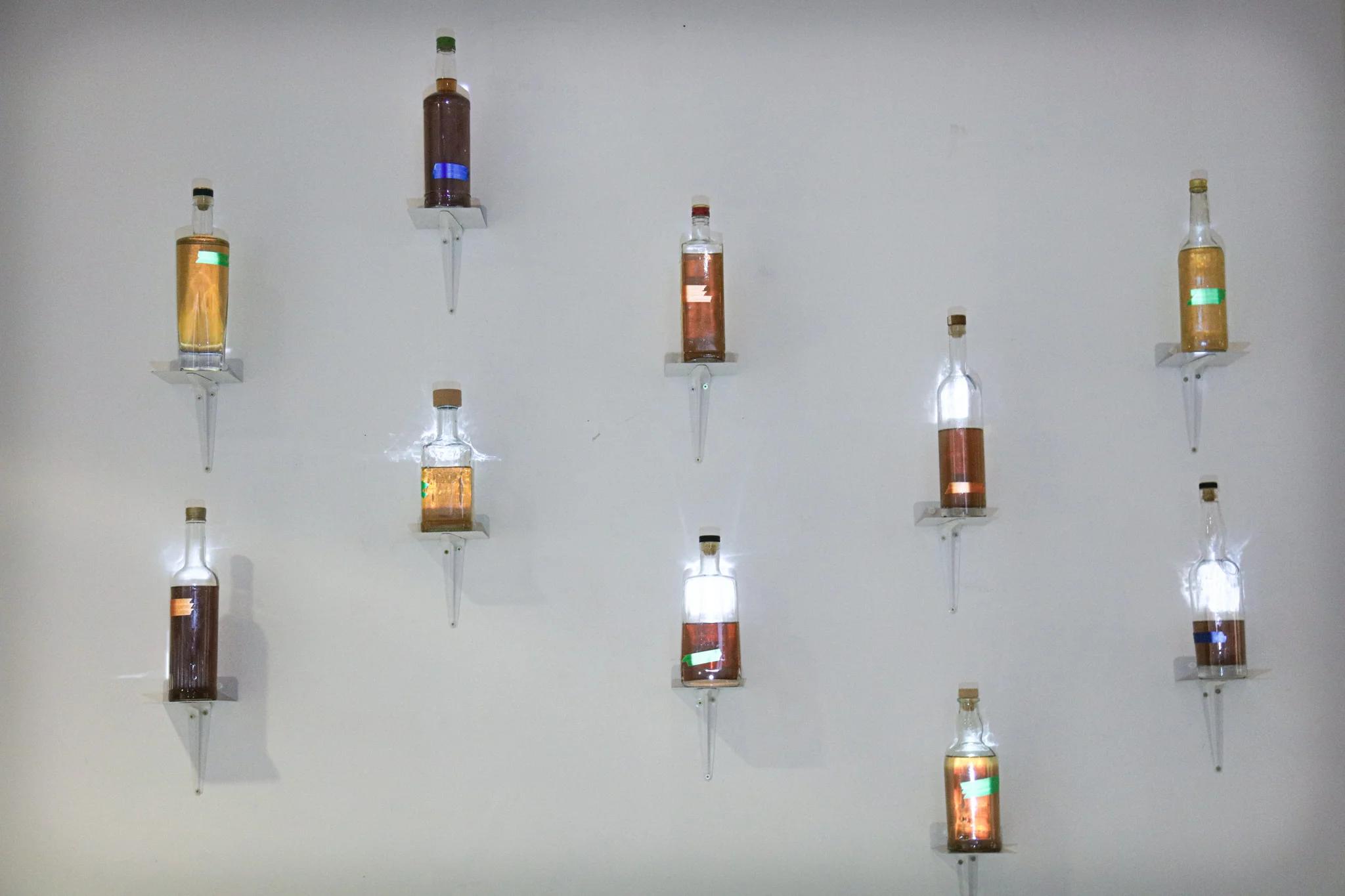 Bottles on a wall, lit up