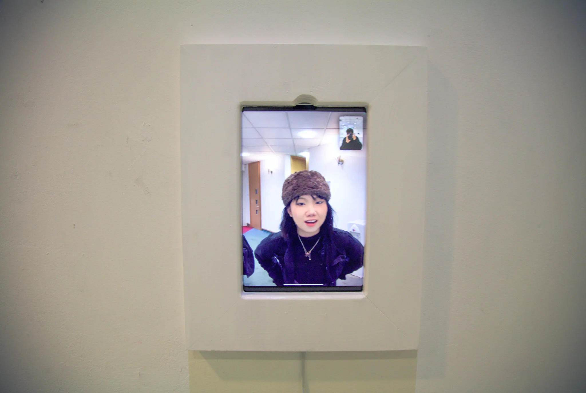 An iPad on Facetime, blending into the wall