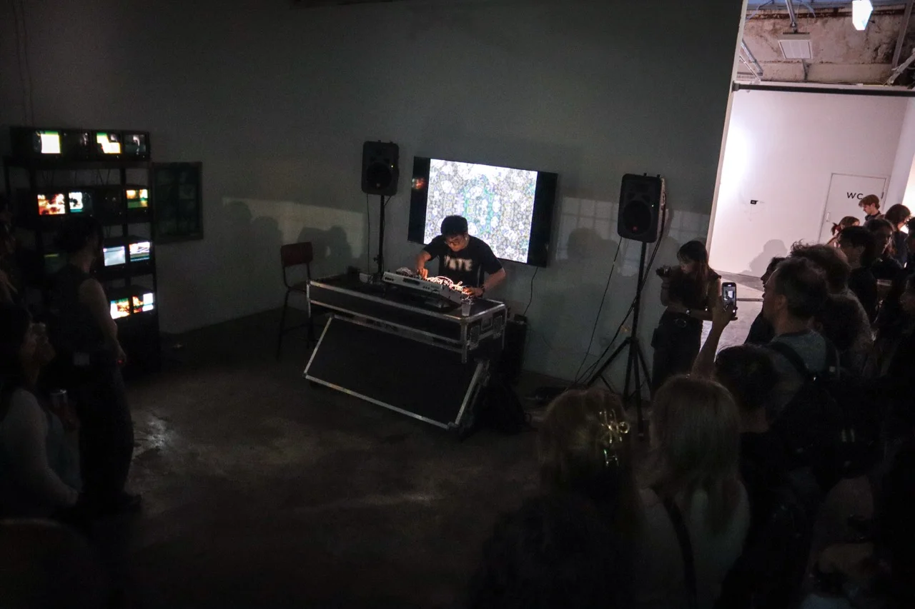 Yiding Zhang performing at Phreaking Collective's BitRot exhibition, London, 2025